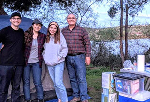 Dr. Romney camping with his family.