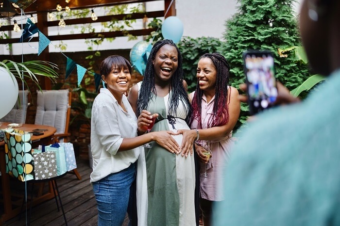 African American women at bridal shower with black pregnant mom