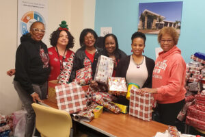 Dr. Chanelle Calhoun wrapping presents with Delta Sigma Theta sisters