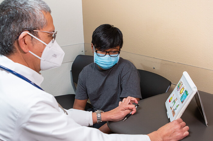 doctor assessing boy for learning disabilities