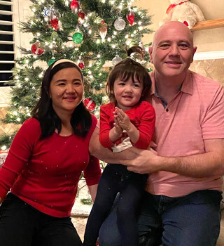 Rami fodda family posing in front of the christmas tree