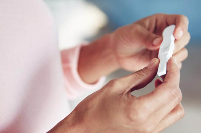 Cropped shot of a woman waiting for the results of a pregnancy test