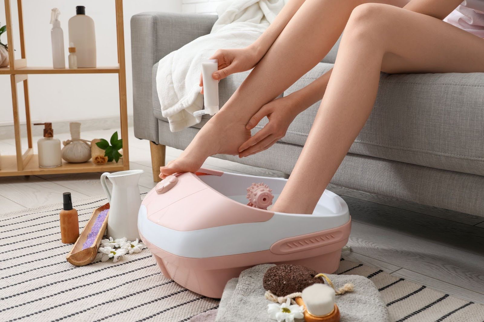 Woman soaking, exfoliating, & moisturizing feet to treat calluses and corns